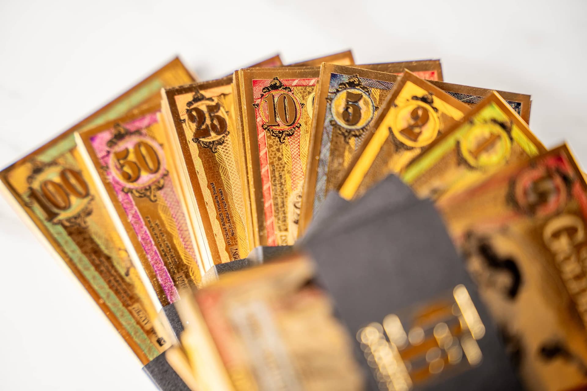 Oklahoma Goldback currency notes fanned out